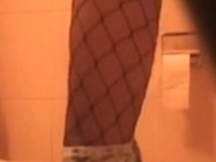 Sexy amateur pissing on toilet wears fishnet and short skirt
