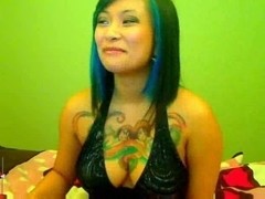 Asian babe with big tattooed breasts poses on adult cam