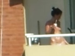 girl sunbathing topples un bacony in argentina.
