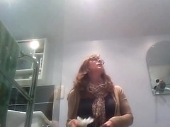 Sexy milf looking around when pissing on the toilet