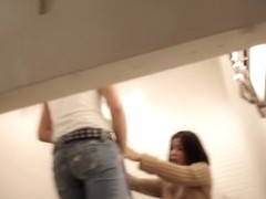Girl helps man try on jeans in the fitting room