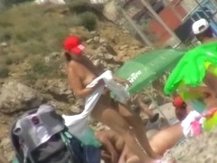Nice babes are being filmed on camera on the beach