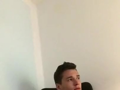 Teen jerks his big cock while watching porn