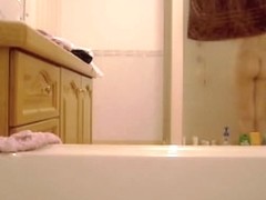 Laura in the bathroom strips and gets booty voyeured