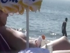 Voyeur watching a large-boobed mother I'd like to fuck on a beach