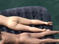Beach Nudists Relaxing On A Beach Raft