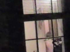 Naked bimbo is dancing and getting spied thru window