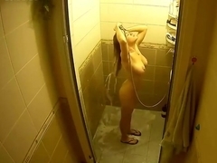Busty blonde taking shower