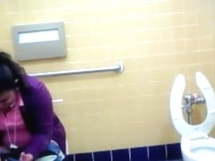 Mature Mexican woman goes pee in a public bathroom