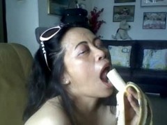 THAI OLDER LADY SHOWING HER LARGE LOVE BUBBLES AND ENGULFING BANANA