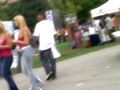 Sweet ass blonde girls get followed by a voyeur cameraman on a festival