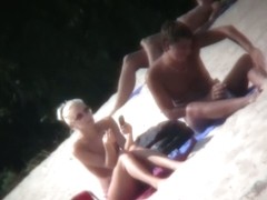 A couple sizzling hot blondes tanning in a nudist beach porno