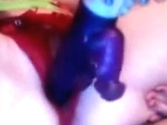 Adorable lady playing with a big purple dildo