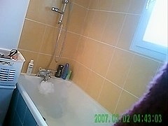 Hot chick showers in voyeur video