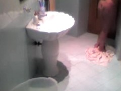 Hidden camera voyeur video with brunette in the bathroom