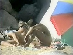 Voyeur spies on older couple having beach joy.avi