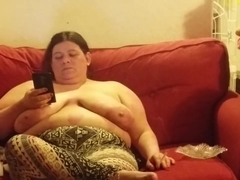 wife chilling on her phone top less smoking