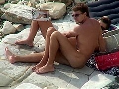 Breasty slut sucking cock on a beach