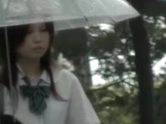 Asian schoolgirl gets street sharking on a rainy day.