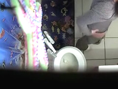 Camera installed in a ceiling filming women pissing