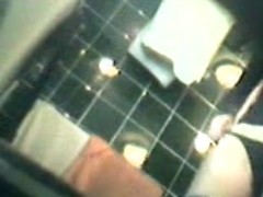 Amazing chick is pissing in the public toilet on voyeur cam