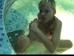 Cute blonde model playing in the pool